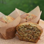 half of a bran muffin on a cutting board