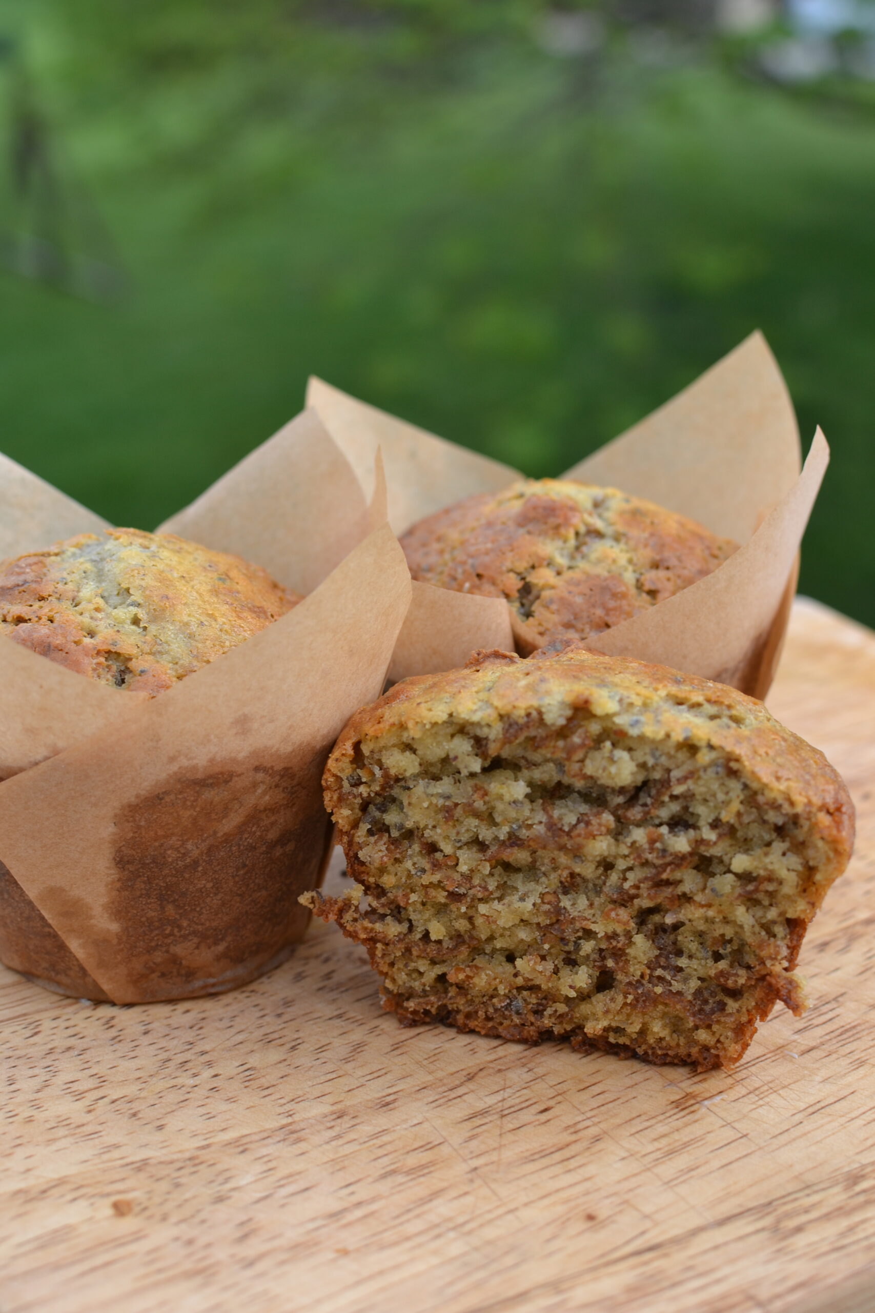 half of a bran muffin on a cutting board
