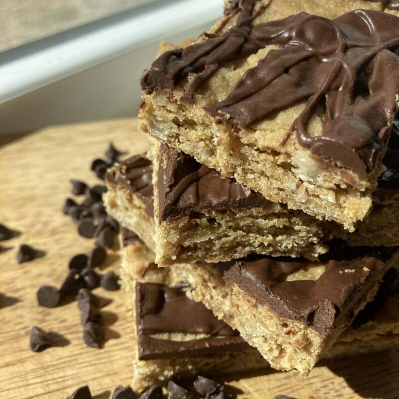 Square cookies with drizzled chocolate stacked