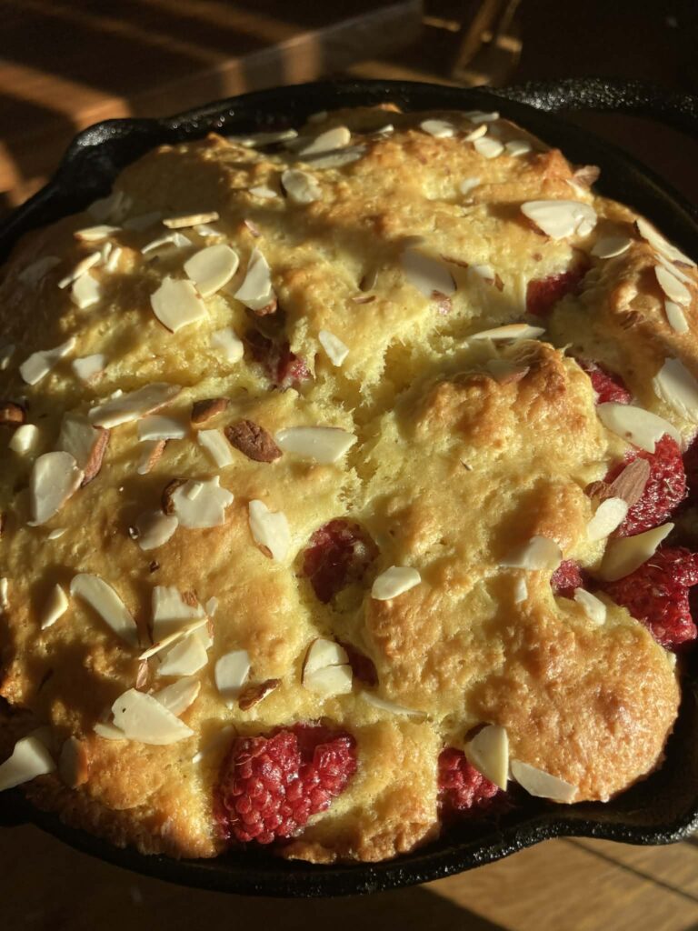 raspberry almond coffee cake in an iron skillet