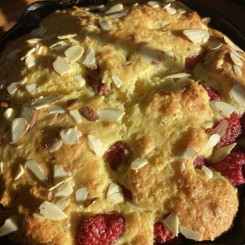 raspberry almond coffee cake in an iron skillet